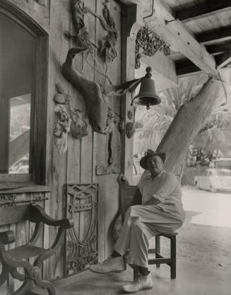 Untitled (Waldo Sexton seated in chair on porch at the Driftwood Inn, Vero Beach, Florida)