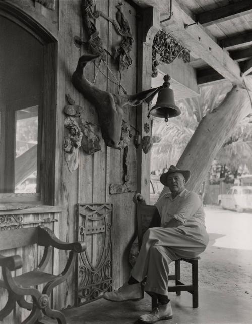 Untitled (Waldo Sexton seated in chair on porch  at the Driftwood Inn, Vero Beach, Florida)