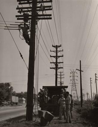 Untitled (crew working on utility poles)