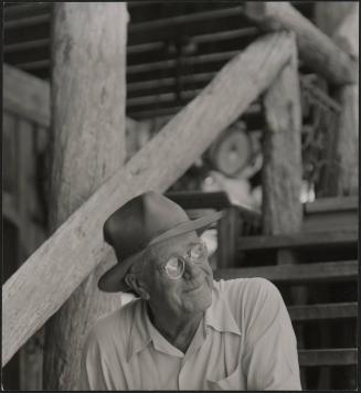 Untitled, (Waldo Sexton, wearing glasses,seated on steps at the Driftwood Inn, Vero Beach, Florida)