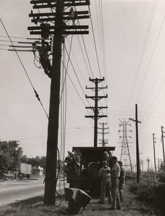 Untitled (roadside crew working on utility pole)