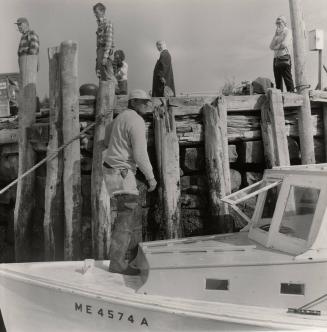 Fishermen standing on a docked boat (Stonington, Maine?)