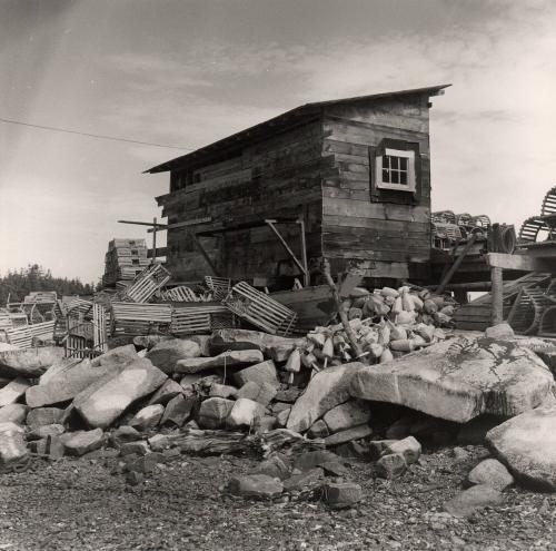 Fishing shack with lobster traps, dory and buoys (Stonington, Maine?);