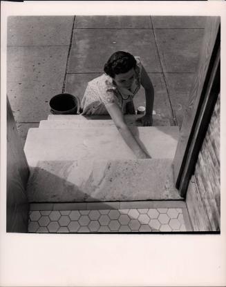 White woman washing white steps, Baltimore, MD