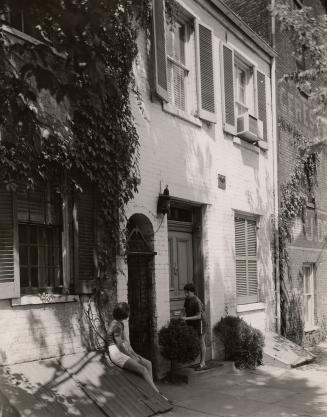 Two girls in front of a building