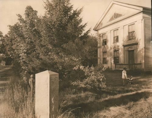 Two girls talking in a yard