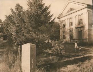 Two girls talking in a yard