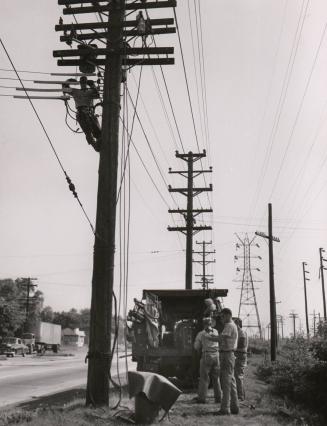 Untitled (roadside crew working on utility pole)